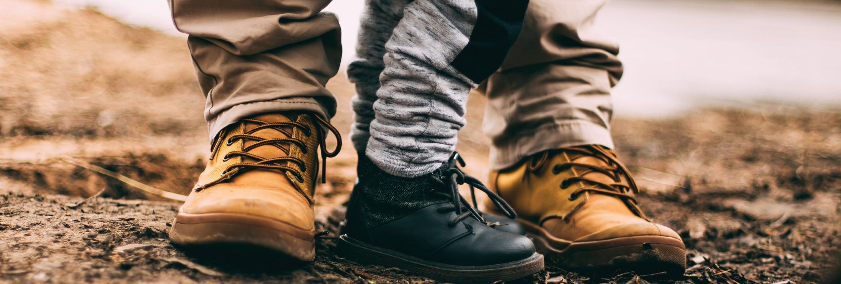 Promo image for the Tax Law changes seminar with a photo of boots of a parent and a small child