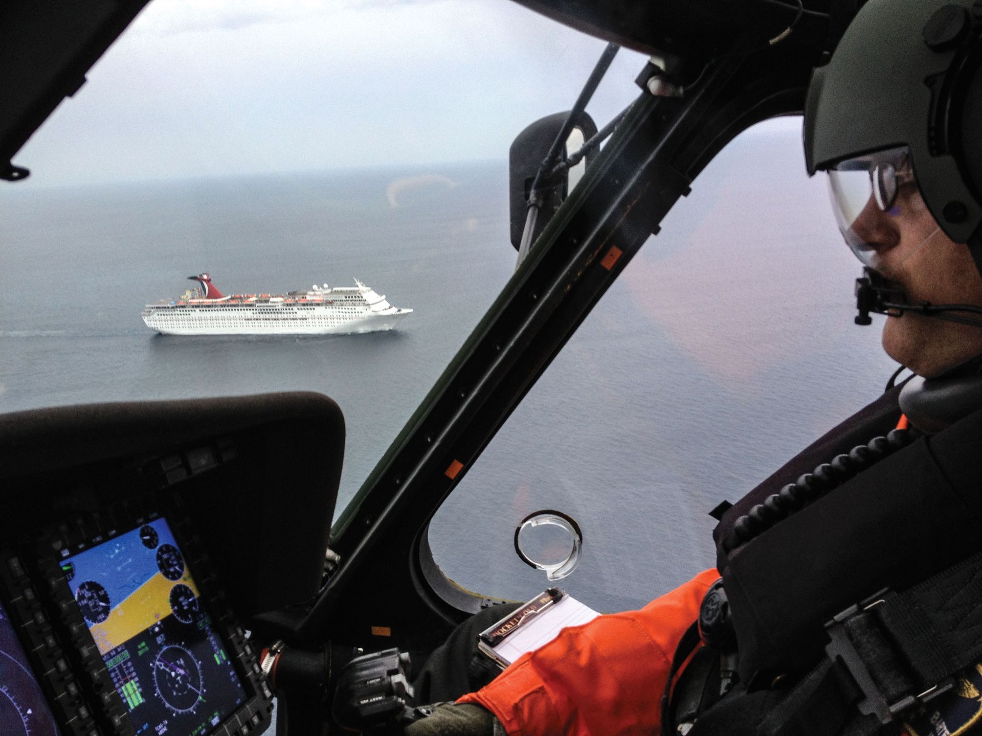 View out a Coast Guard helicopter with Jon at the controls and a cruise ship in the background