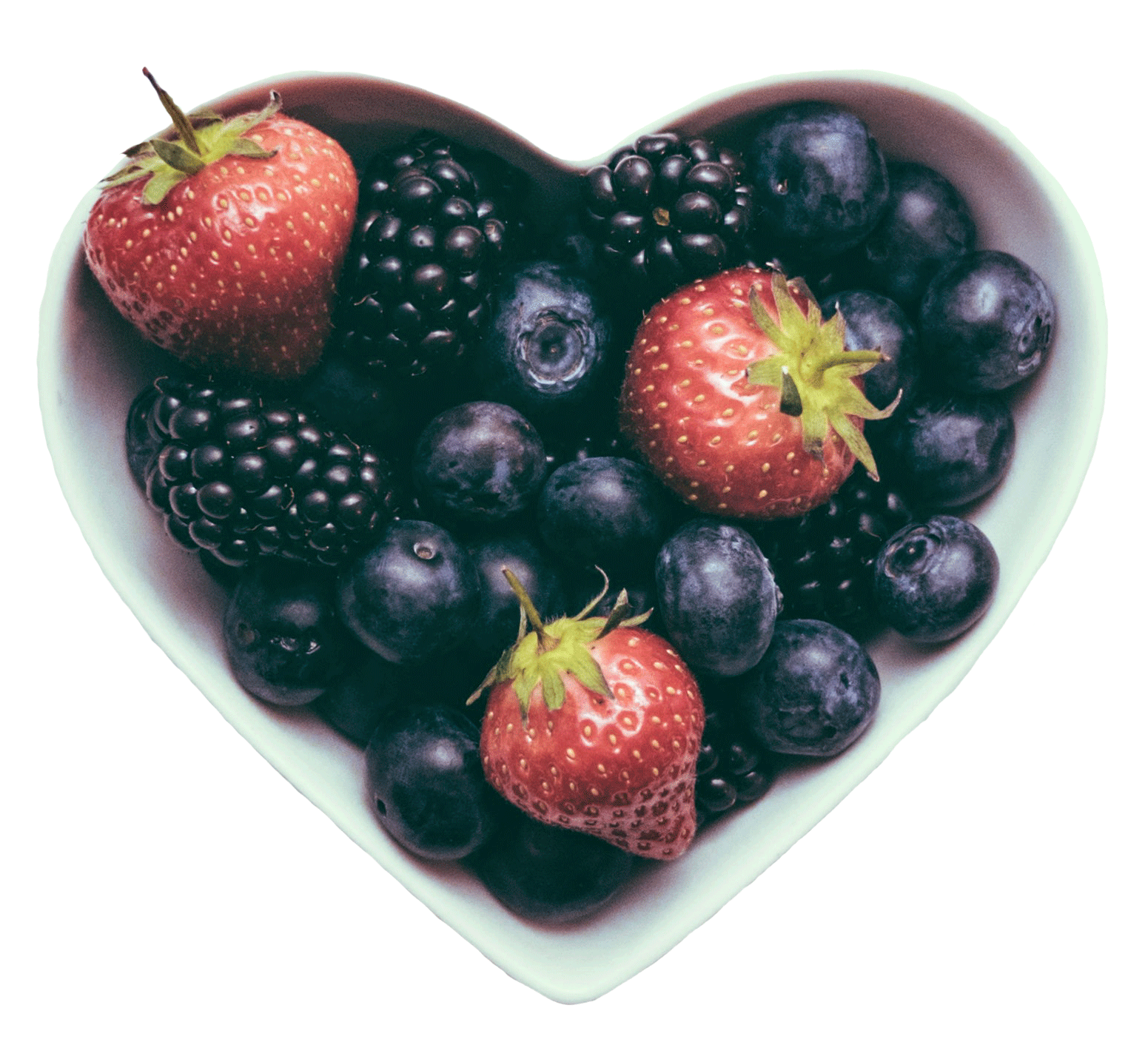 Heart-shaped ceramic dish filled with strawberries, blueberries, and blackberries