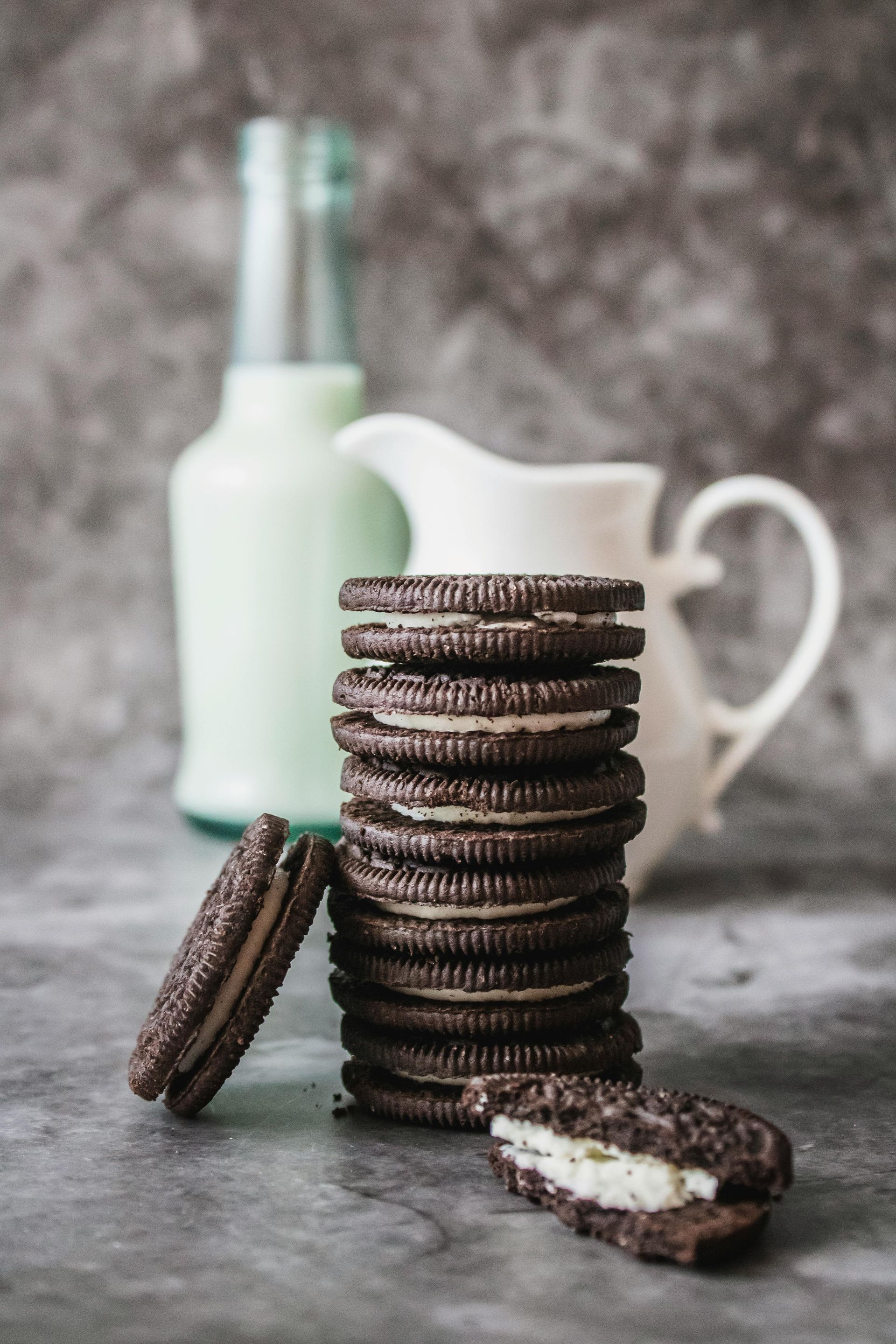 Oreo cookies in foreground with blurred milk jug in background