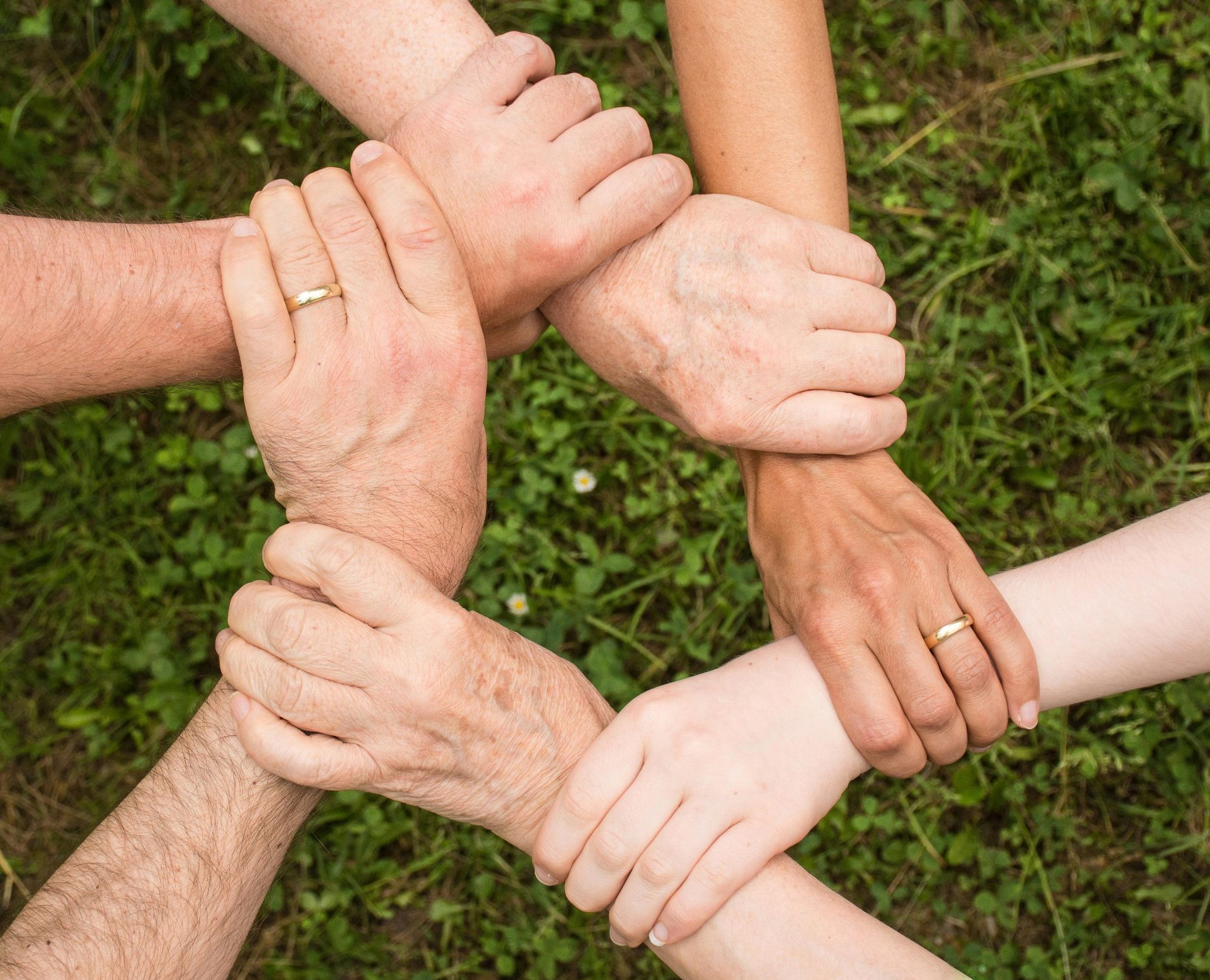 Three students, two girls and one boy, holding a sign that reads