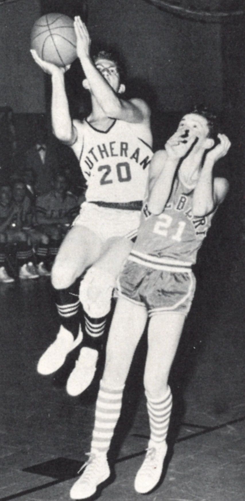 FVL boys basketball teammate shooting basket, with opponent in the way