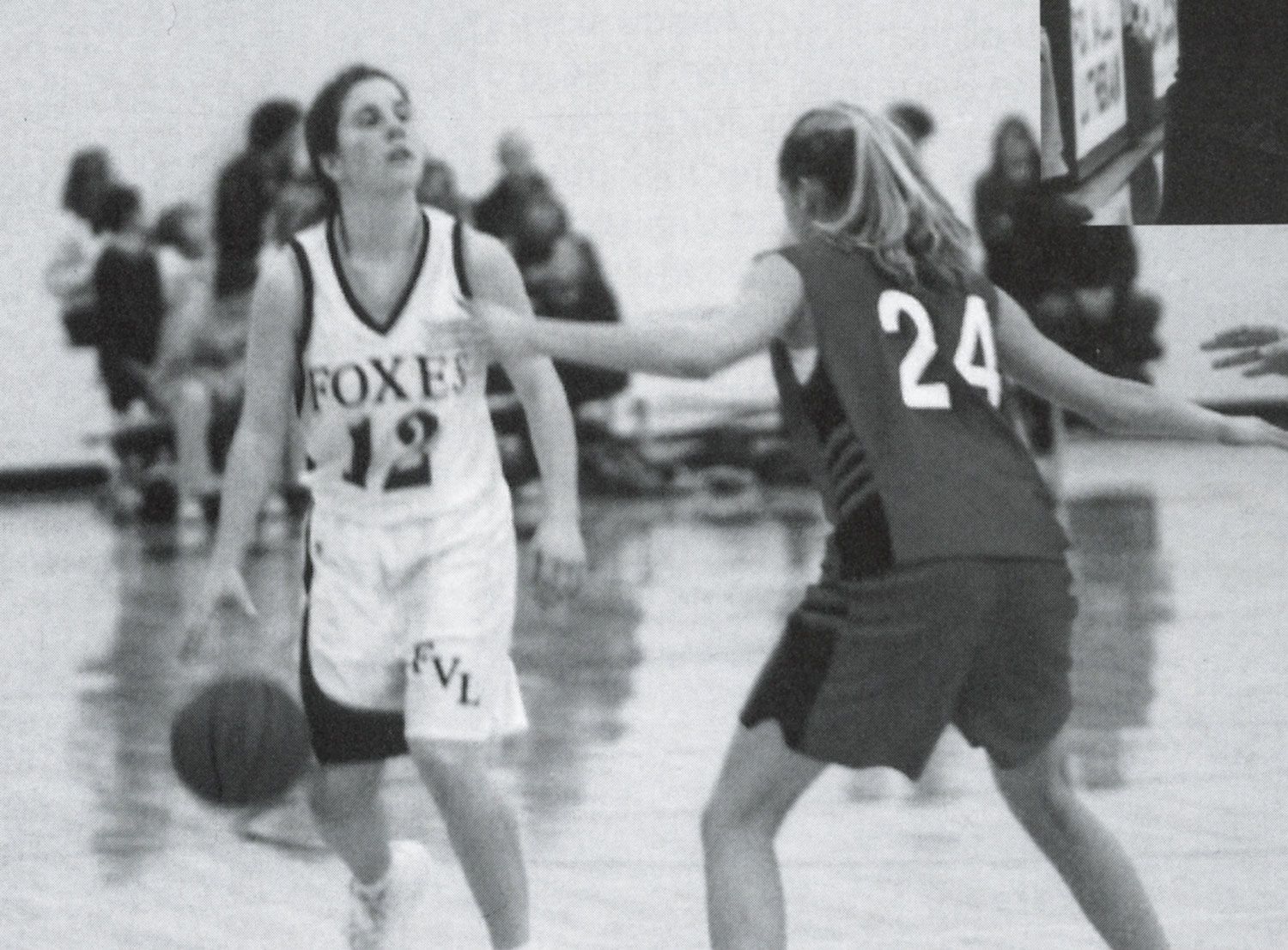 Old yearbook photo of Rachel dribbling during a home game