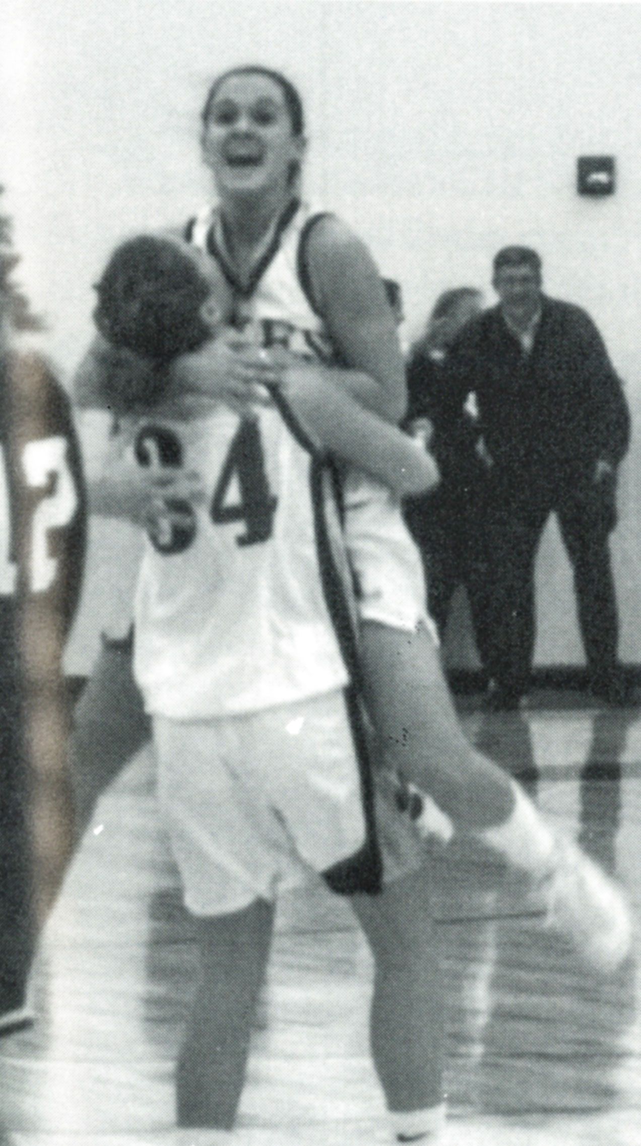Female team member holding another team member in the air after a significant win