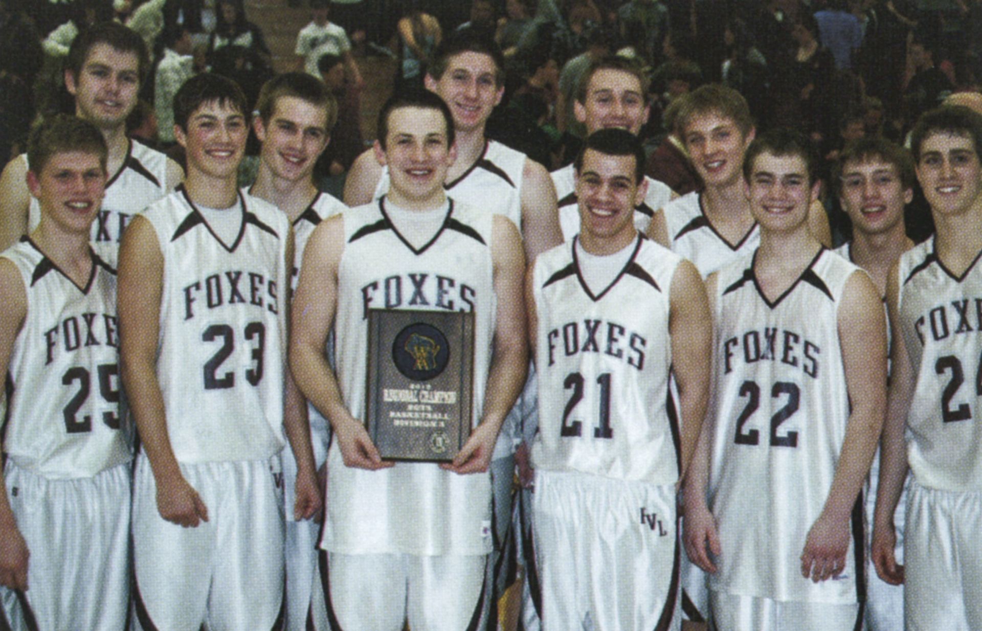 Boys team smiling and holding up plaque they just received for being regional champs