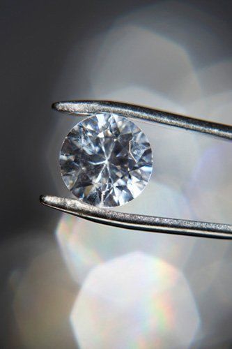 Diamond held by tweezers- Jewelry Services in Saratosa, FL