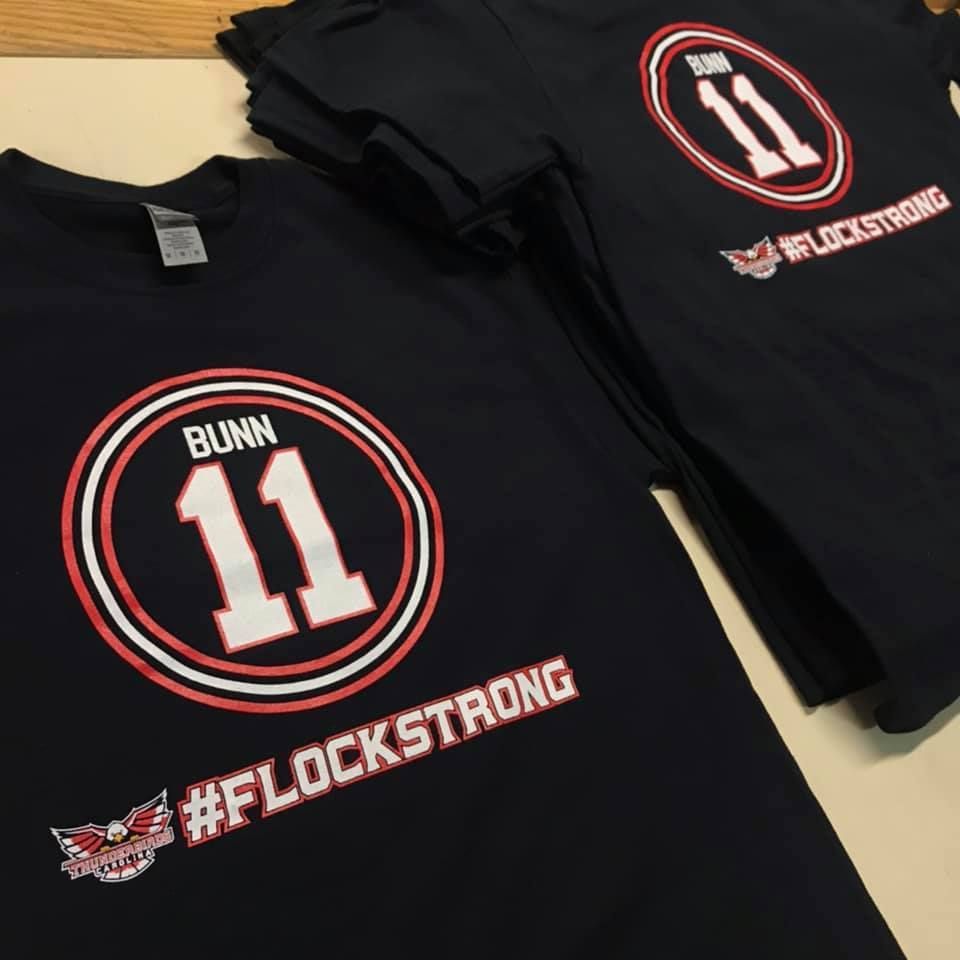 Black t-shirts with white and red circle design including 