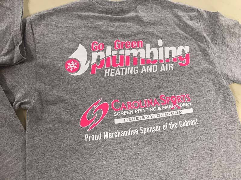Gray t-shirt with pink and white logos for Go Green Plumbing and Carolina Sports screen printing.