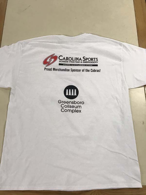 White t-shirt with Carolina Sports logo and Greensboro Coliseum Complex graphic on the back.
