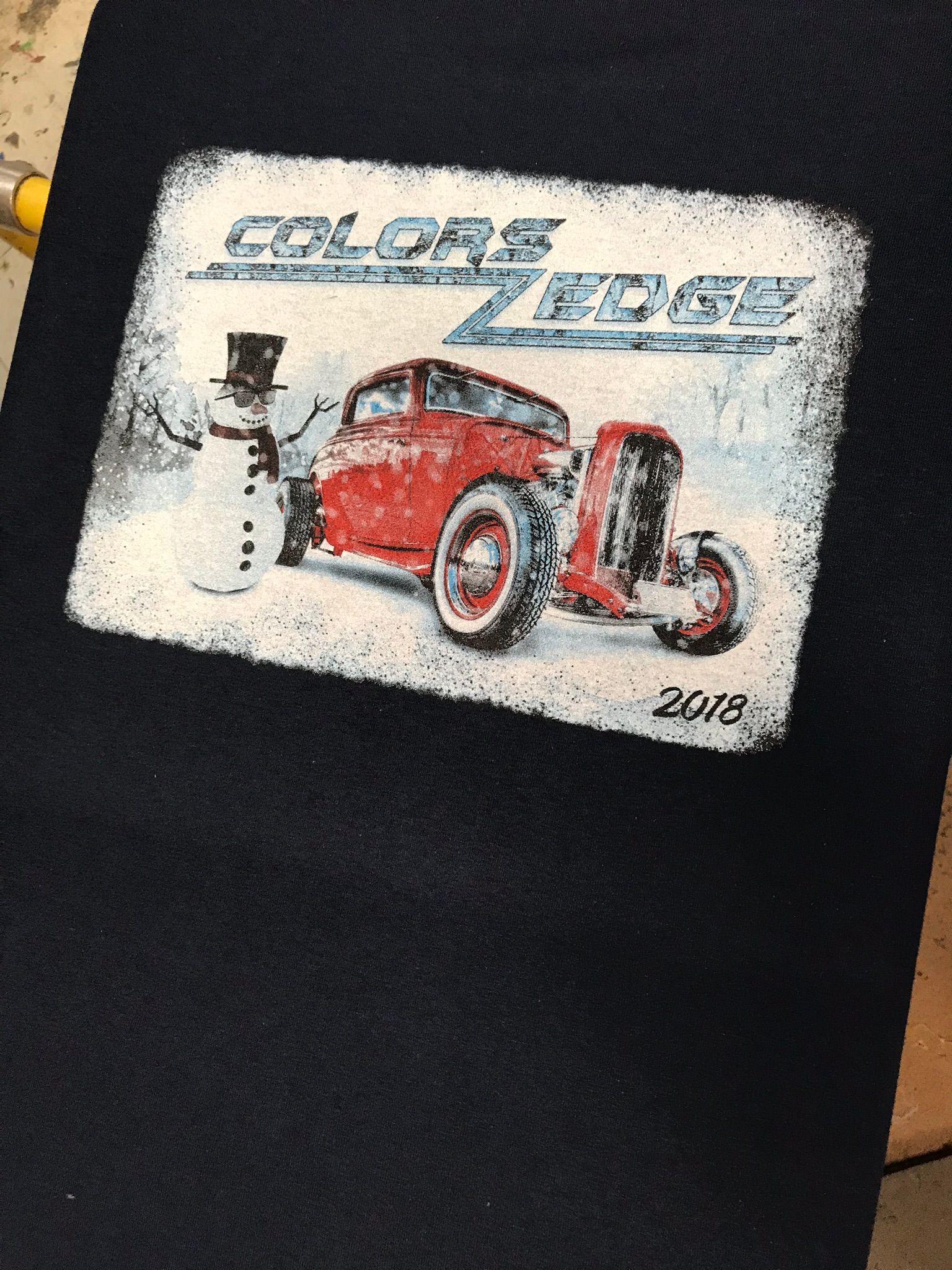 Red hot rod in a snowy scene with a snowman and 