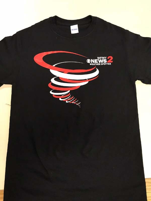 Black t-shirt with a stylized red and white tornado graphic and