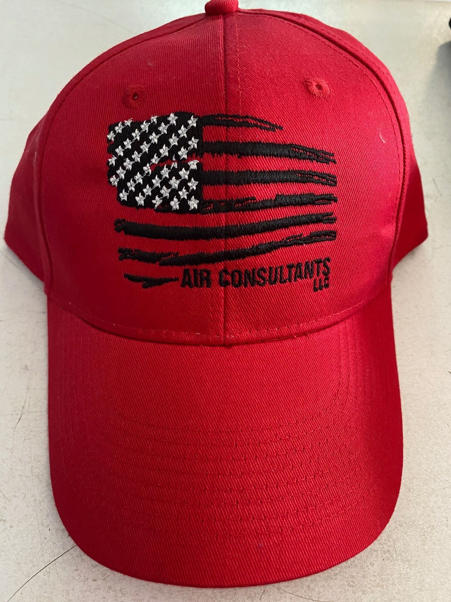 Red baseball cap with a distressed American flag and 