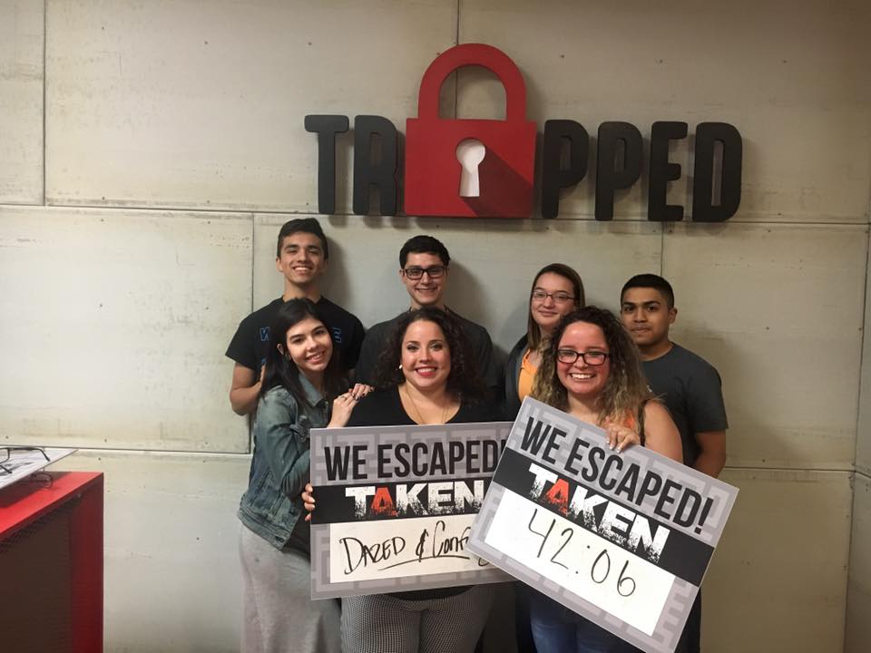 A group of people are holding signs that say `` we escaped taken ''.