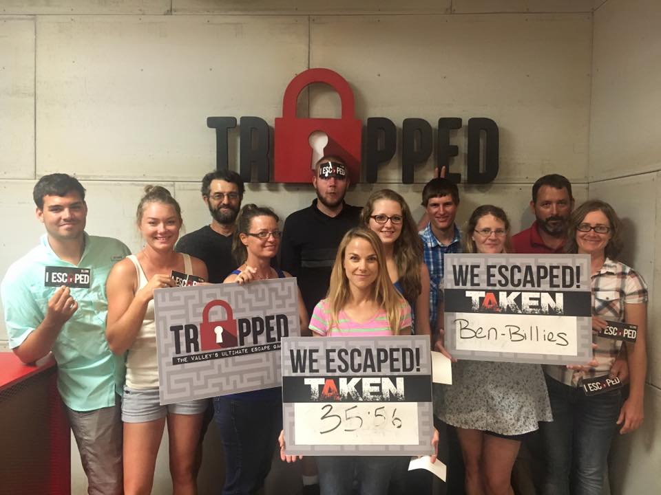 A group of people are posing for a picture while holding signs.