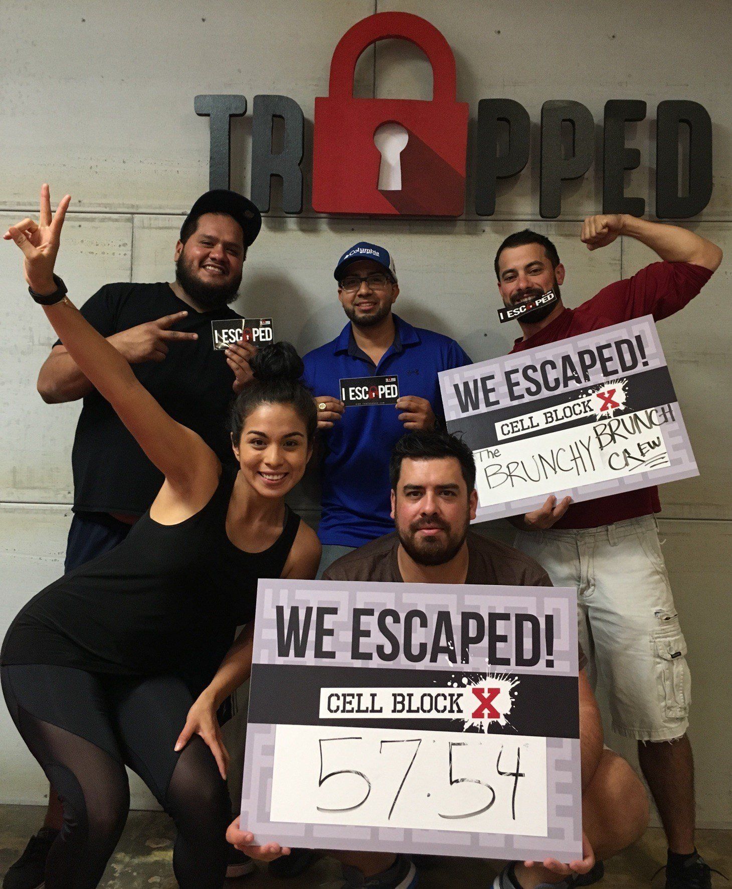 A group of people holding signs that say we escaped