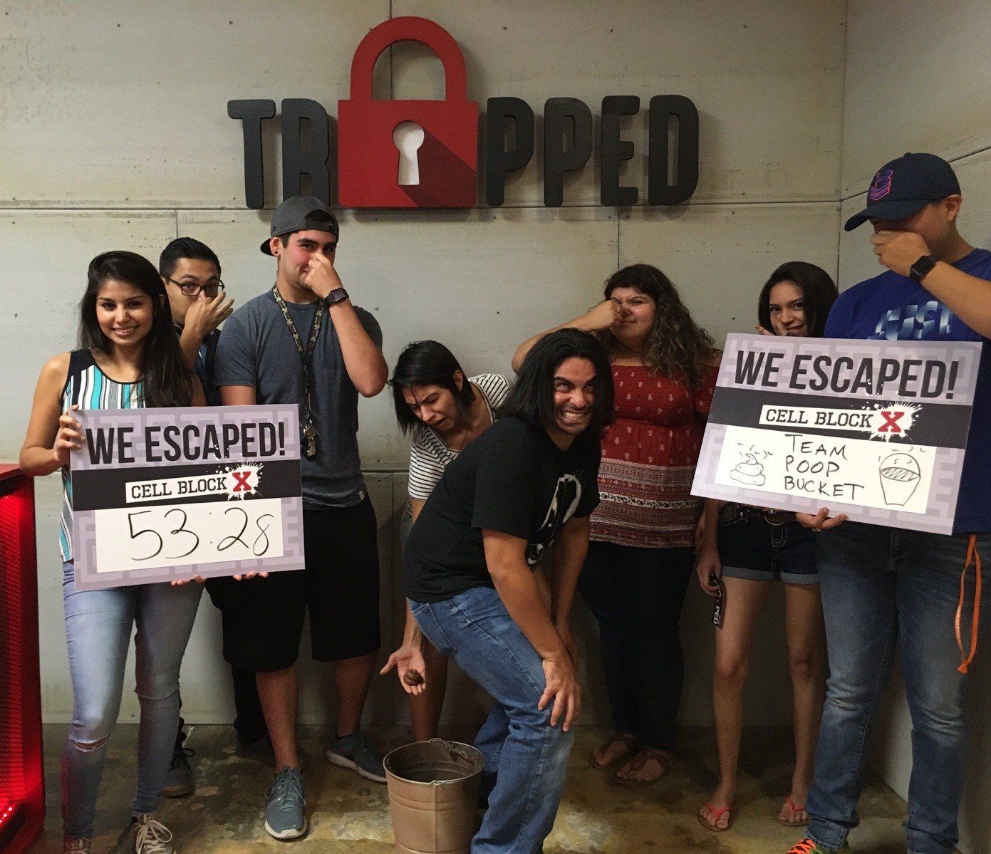 A group of people holding signs that say we escaped