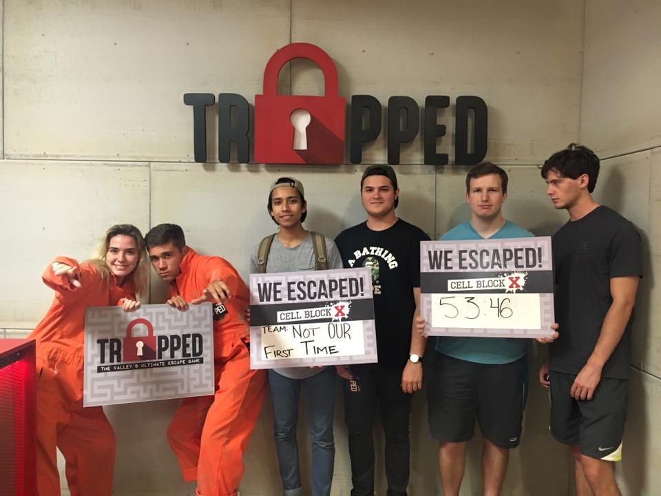 A group of people standing next to each other holding signs that say we escaped.