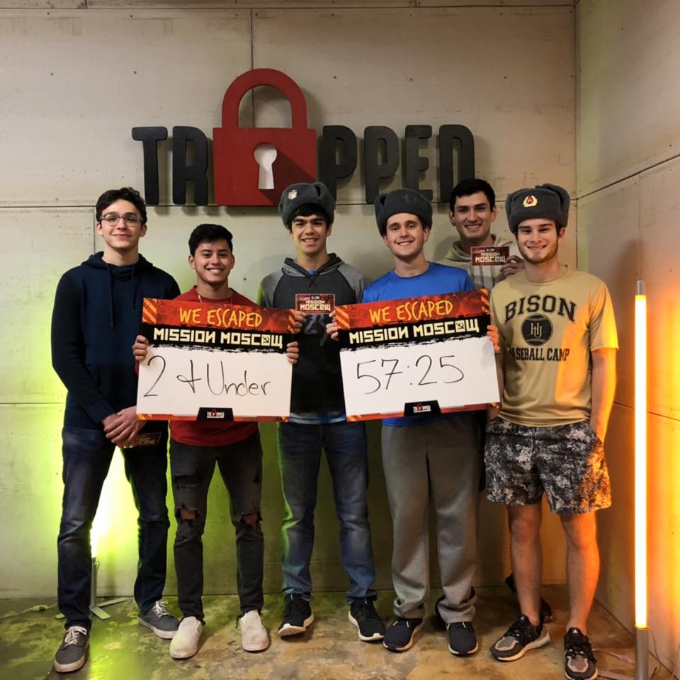 A group of young men are holding signs that say we escaped mission moscow