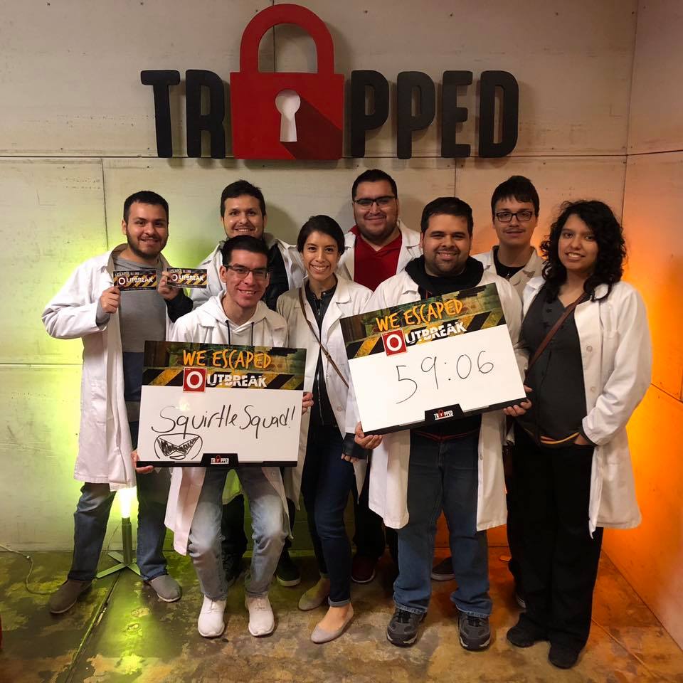 A group of people standing in front of a sign that says trapped