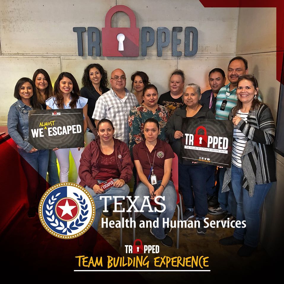 A group of people standing in front of a sign that says trapped texas health and human services