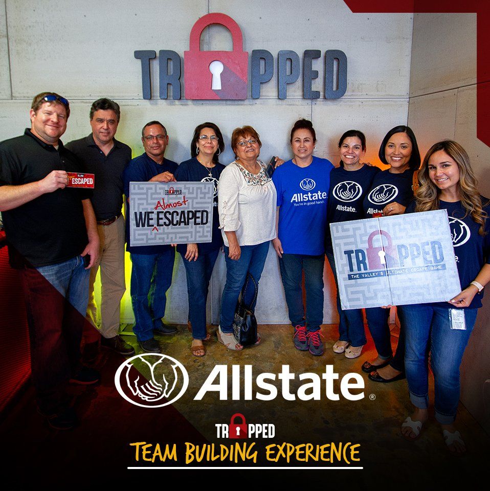 A group of people standing in front of a wall that says trapped