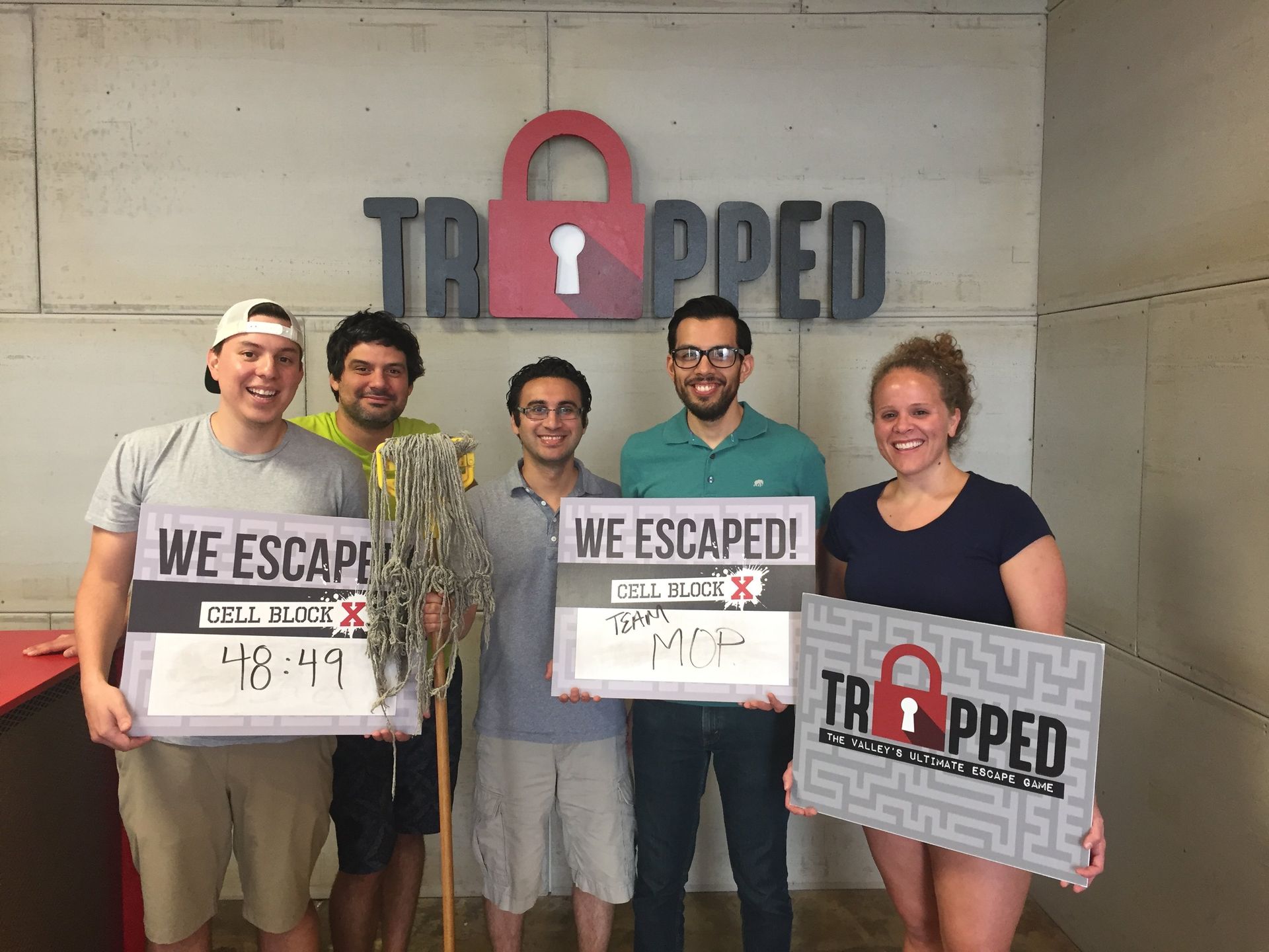 A group of people are holding signs that say `` we escaped ''.