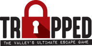 The logo for trapped the valley 's ultimate escape game.