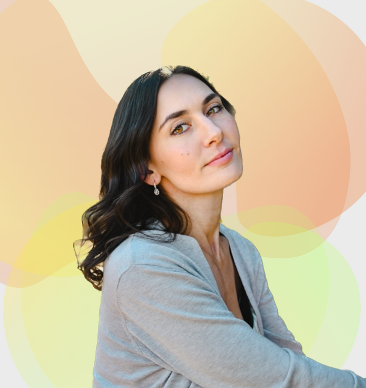 A woman wearing a grey sweater and earrings looks at the camera for a murfreesboro seo company called TN marketing pros .