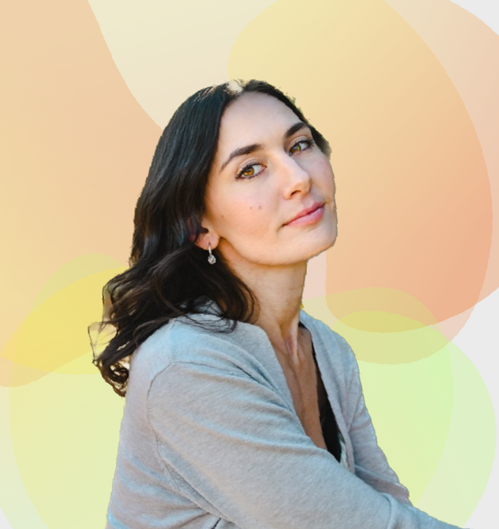 A woman wearing a grey sweater and earrings looks at the camera for a murfreesboro seo company called TN marketing pros .