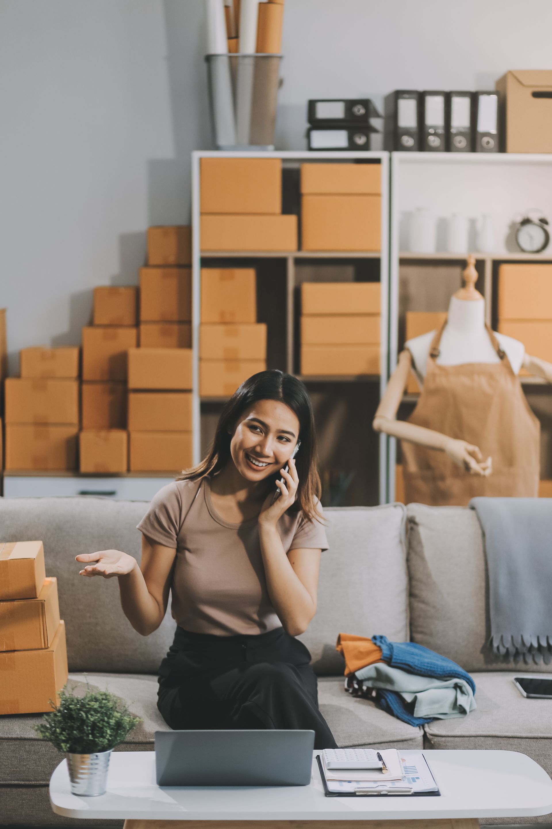 Asian SME business women use laptop computer checking customer order online shipping boxes at home. Starting Small business entrepreneur SME freelance. Online business, Work at home concept. 
