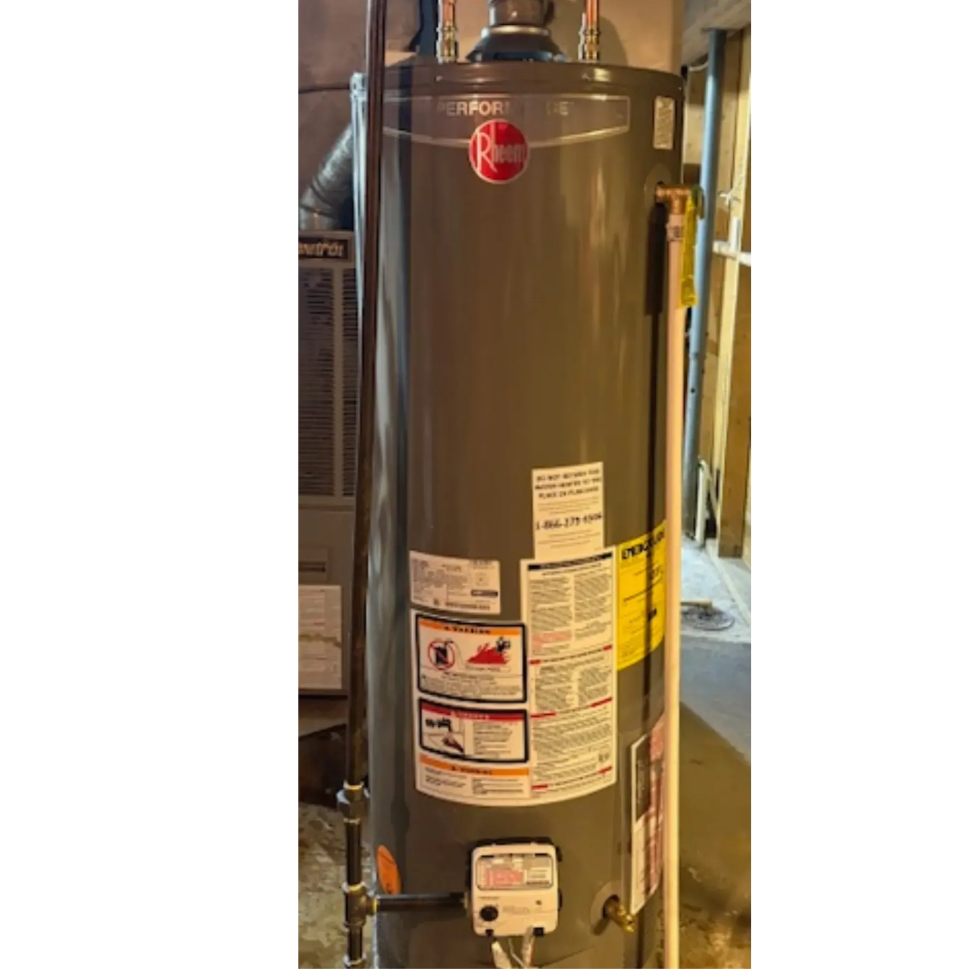 Serenity Home Services LLC - A white water heater is sitting in a basement next to a staircase.