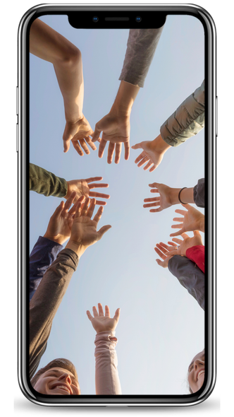 A group of people are standing in a circle with their hands in the air.