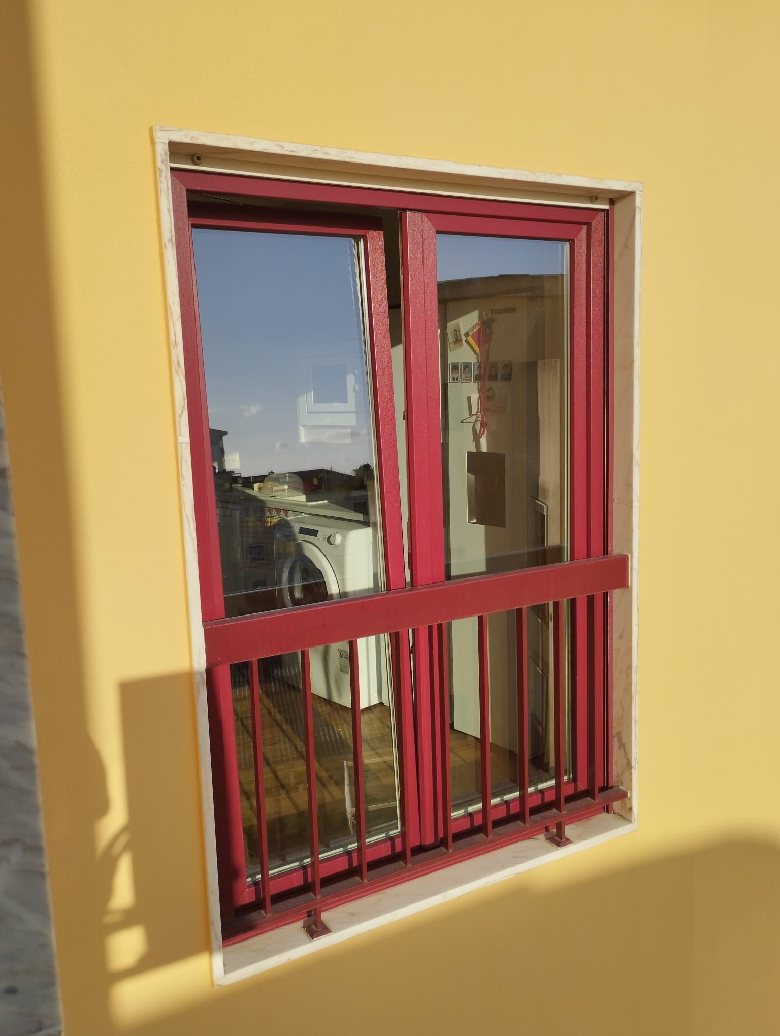 Janela em caixilharia de PVC bordo vermelho