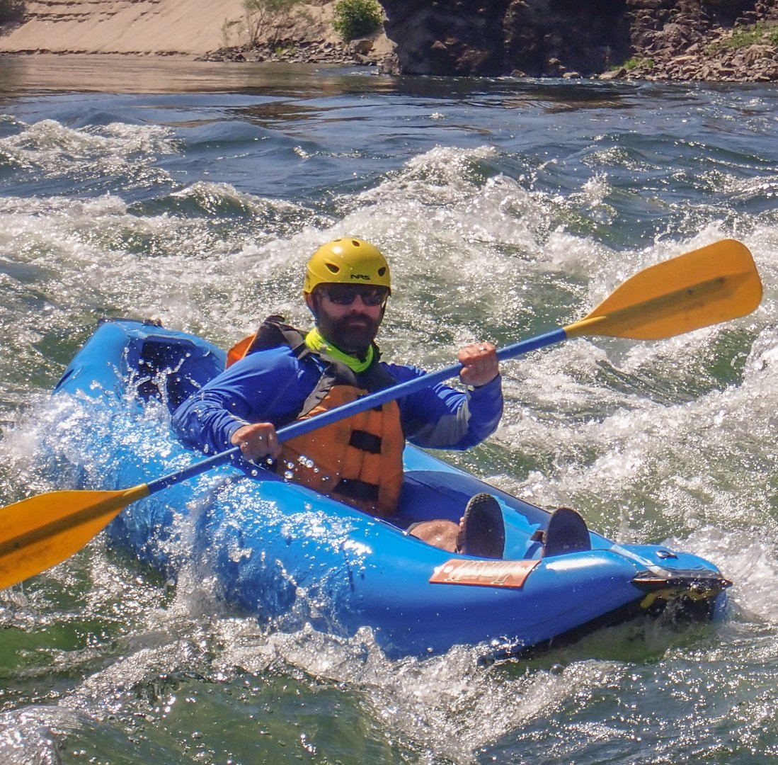 Kayaking on an inflatable kayak on Lower Salmon River in Idaho.
