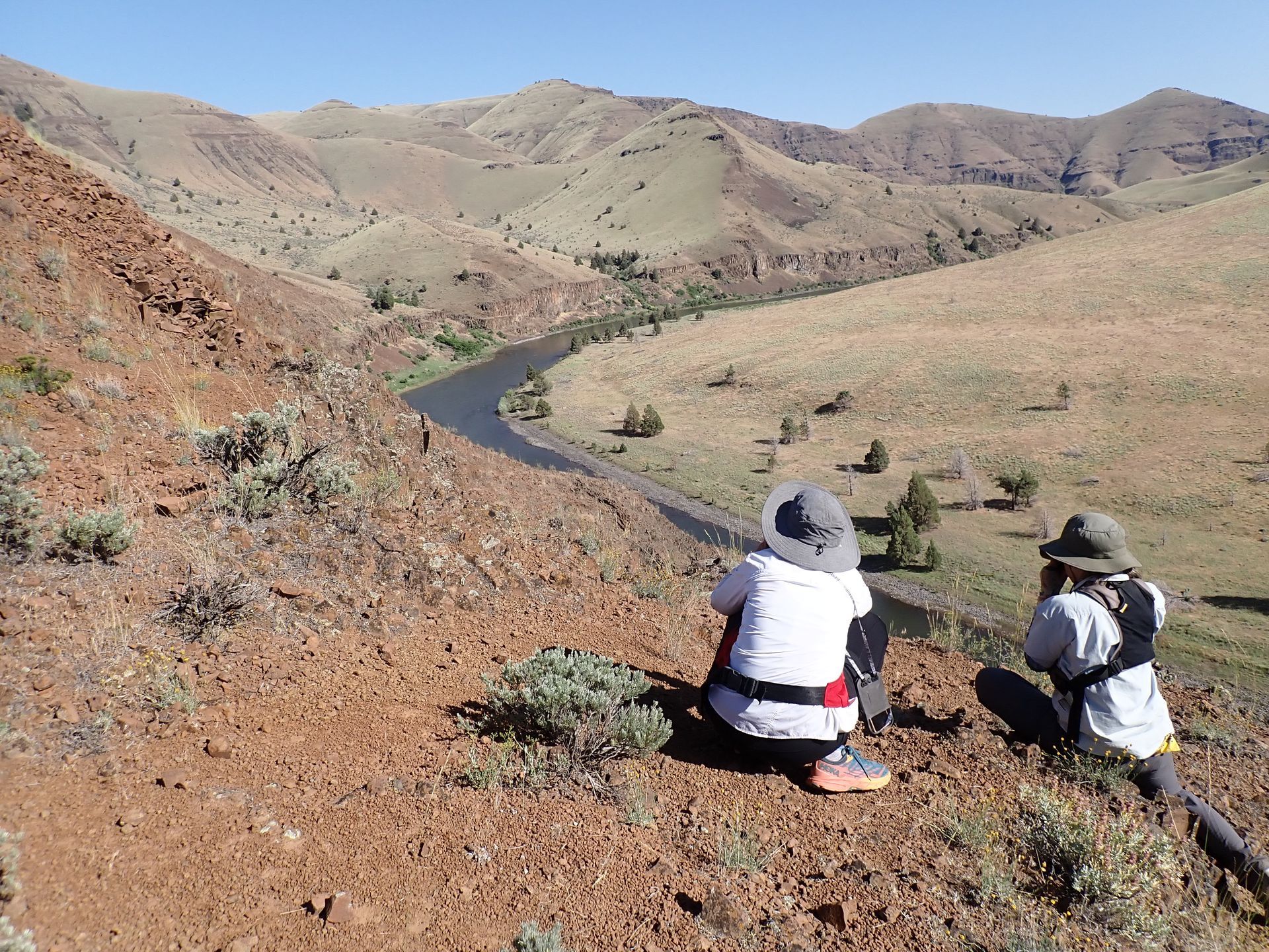 Hikers enjoying a break and taking in the scenery on the John Day River trip. 