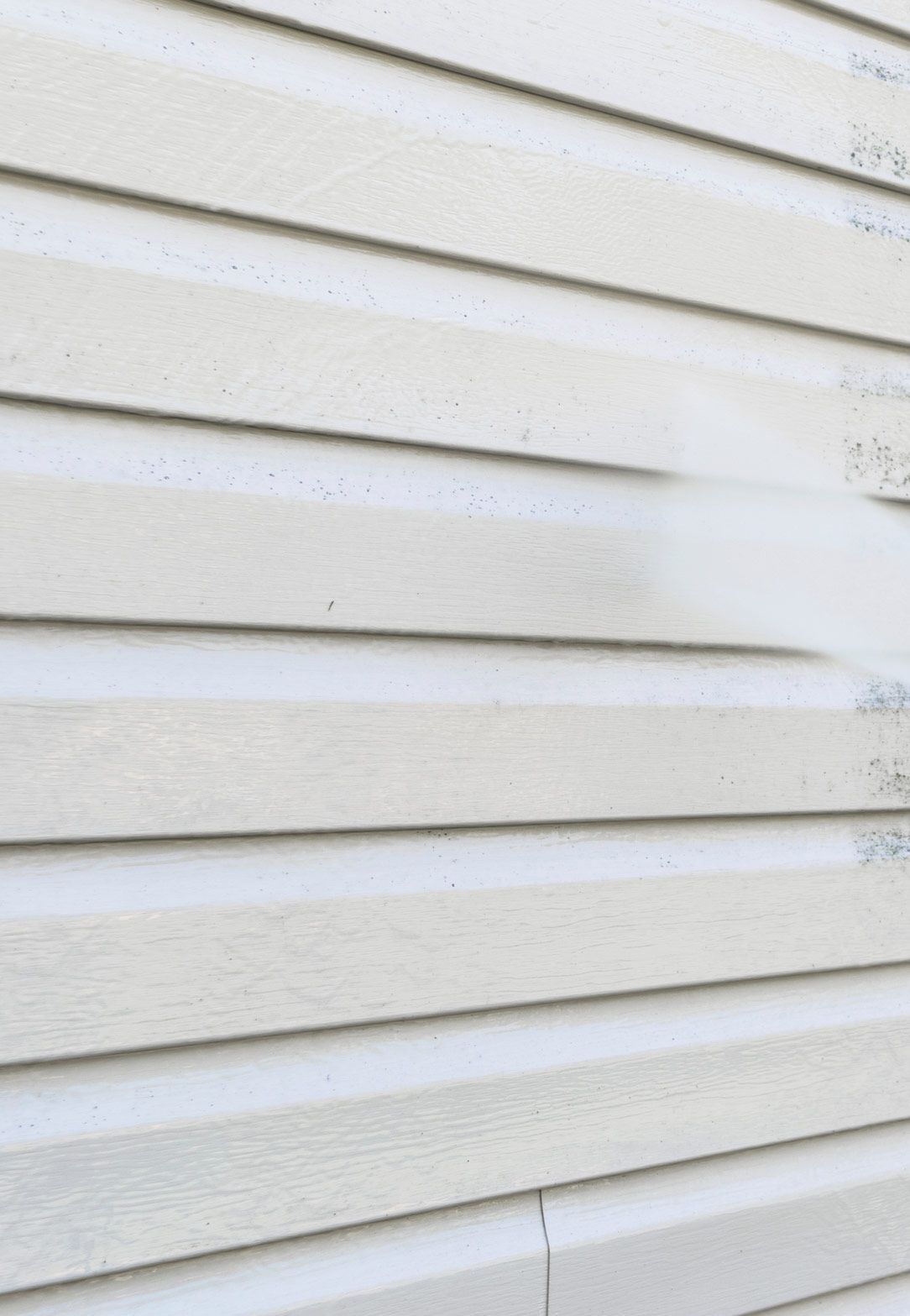 A Close Up of a House Siding Being Cleaned With a High Pressure Washer — RPS–Remote Painting Services in White Rock, QLD