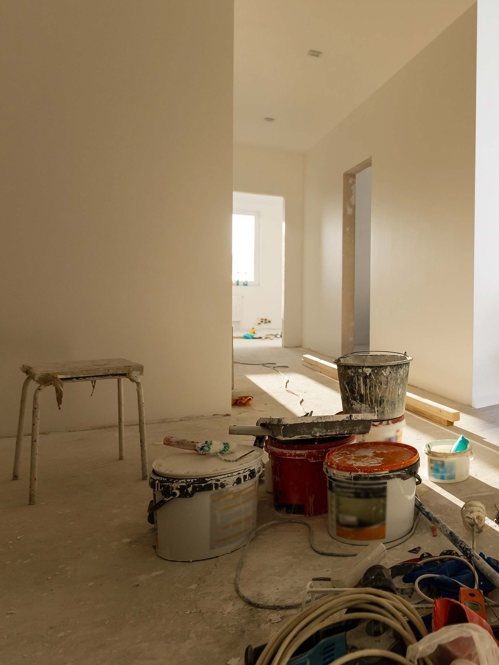 A Room Under Construction With Buckets of Paint and Tools on the Floor — RPS–Remote Painting Services in White Rock, QLD