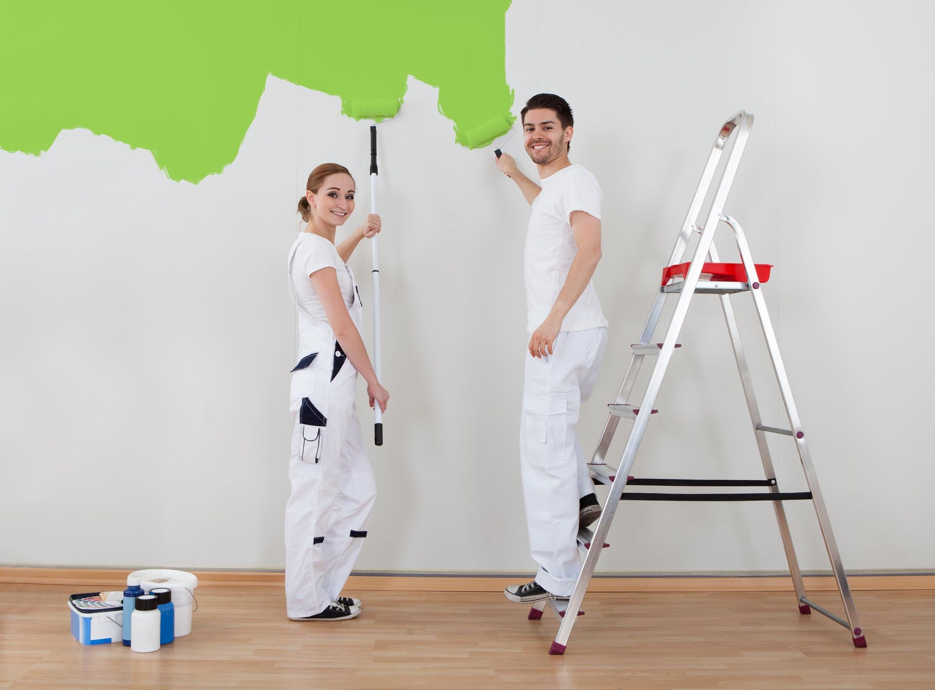 A Man and a Woman Are Painting a Wall Green — RPS–Remote Painting Services in Northern Beaches, QLD