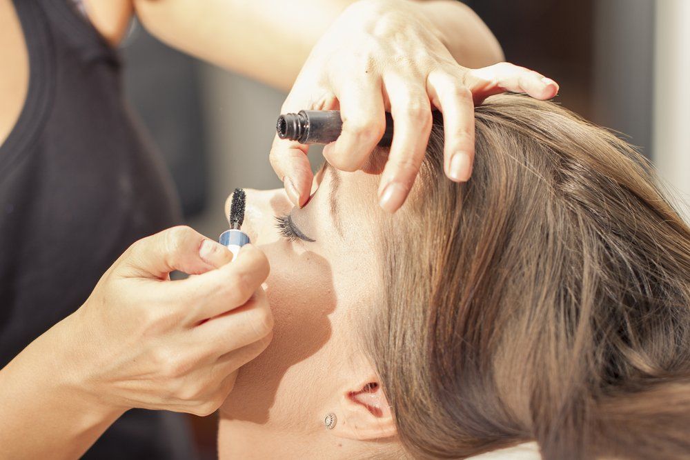 Woman Fixing the Eyelash of the Customer — Hair Salon in Townsville, QLD