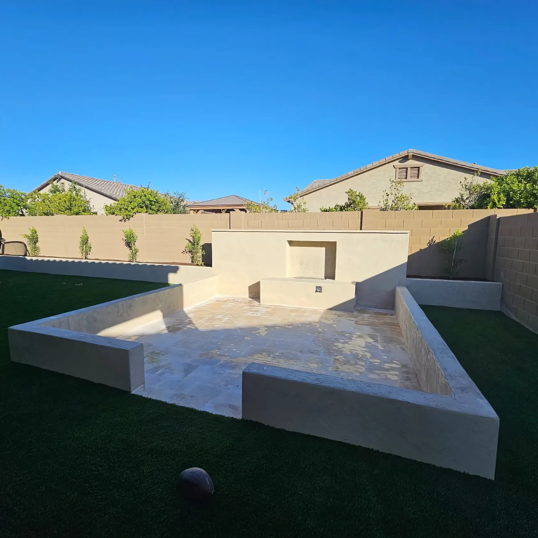 A backyard with a concrete block in the middle of it