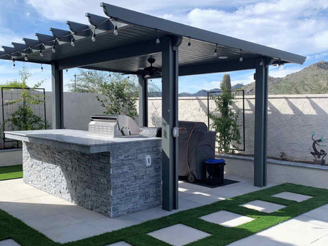 A patio with a pergola and a fireplace next to a pool.