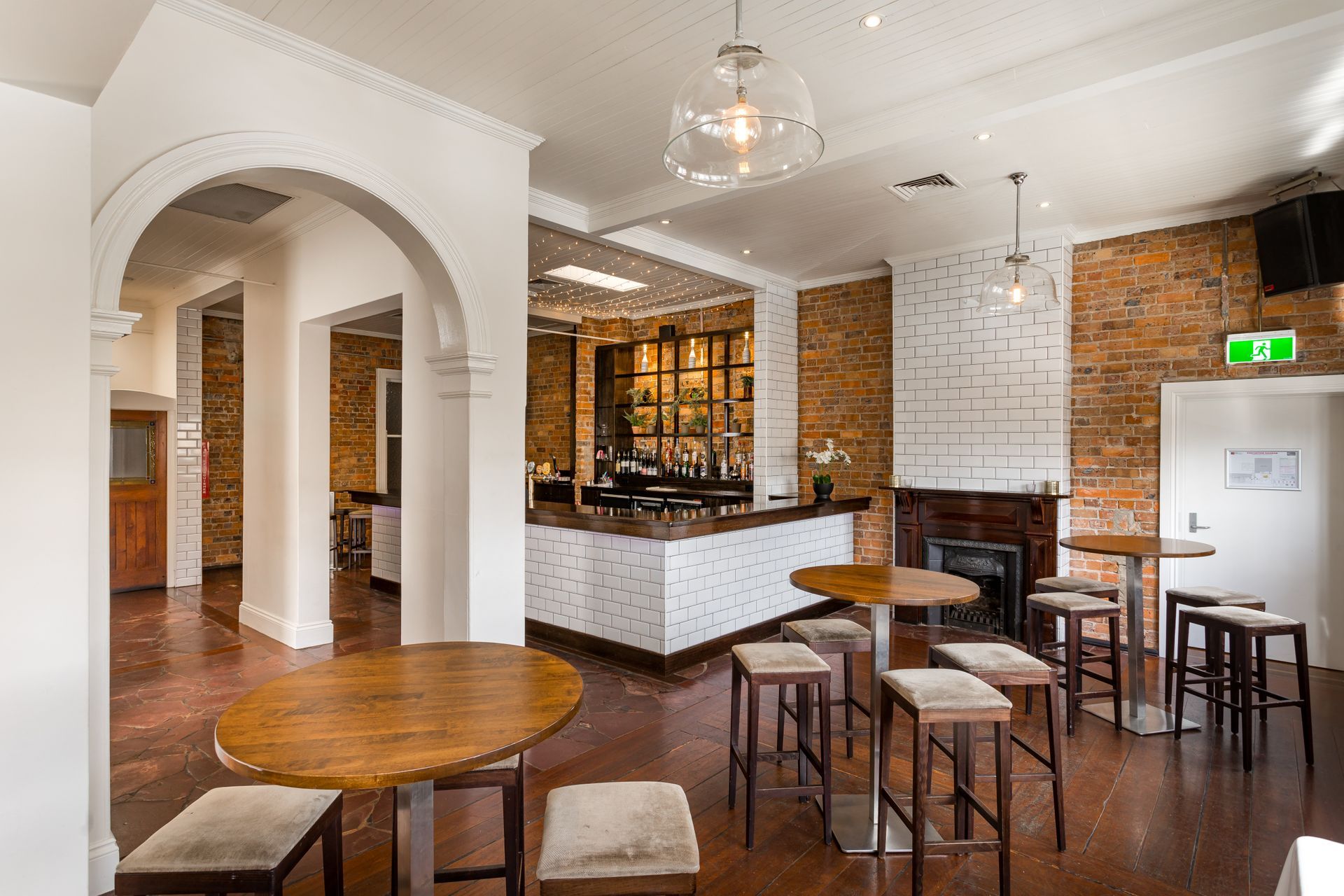 There are many tables and stools in the room.