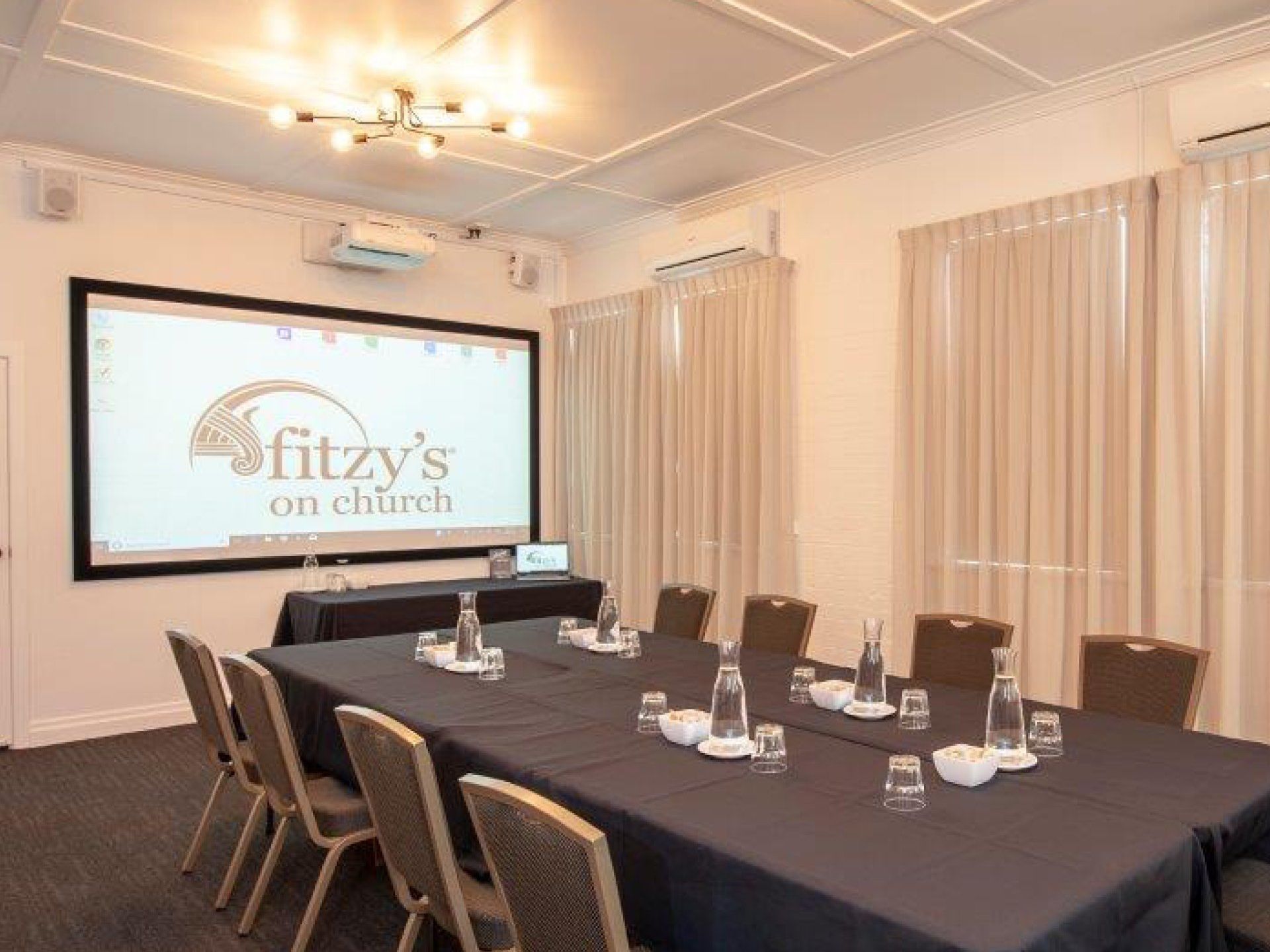 A conference room with a long table and chairs