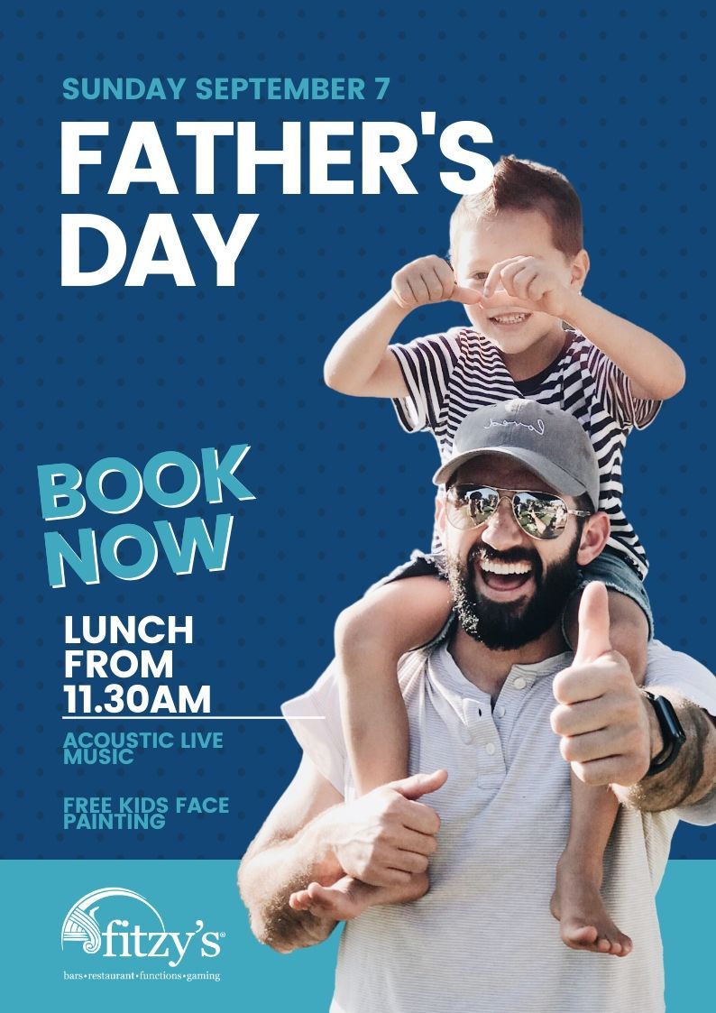A man is carrying a child on his shoulders and giving a thumbs up.
