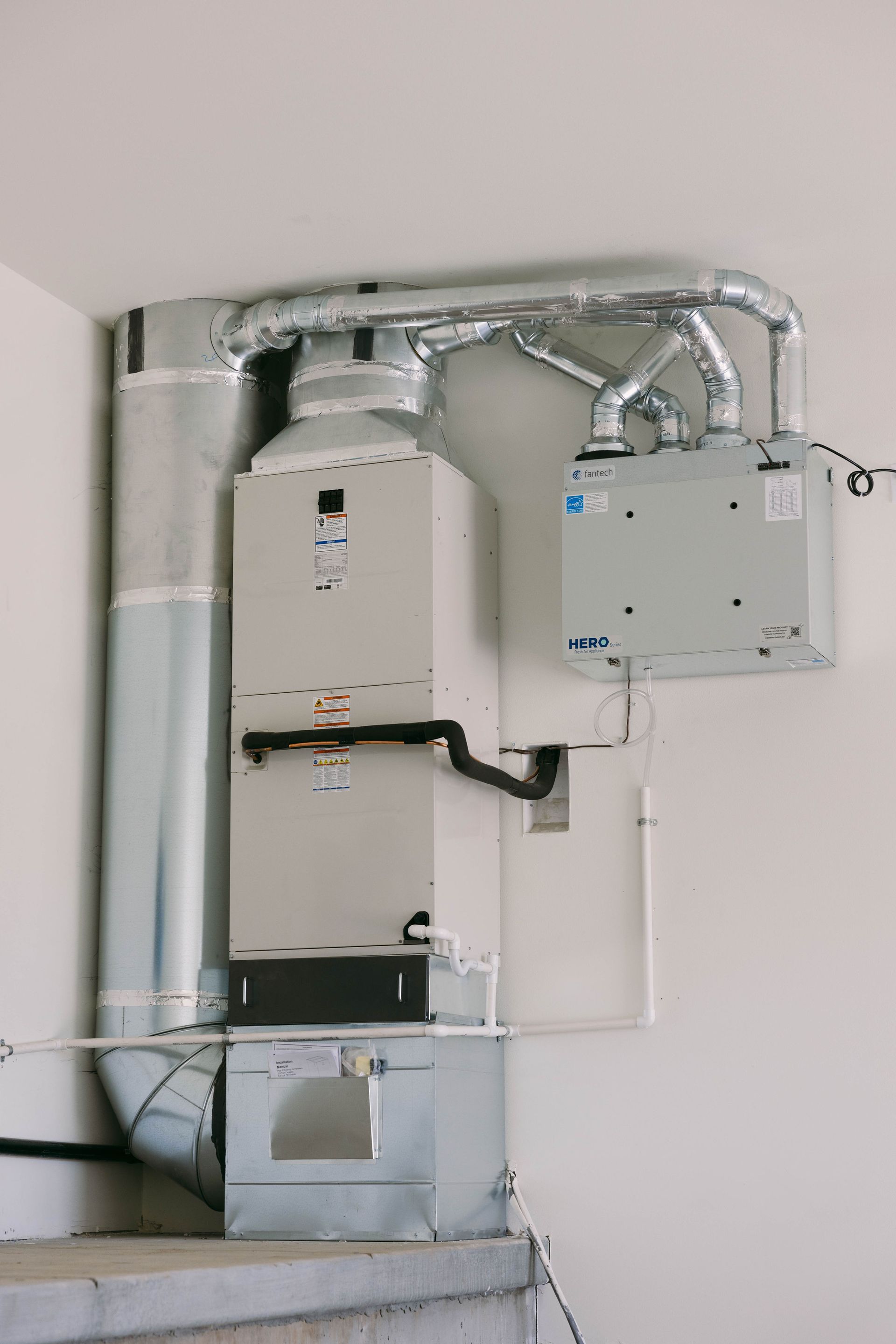 Electrical panel and metal conduit mounted on a wall in a utility room