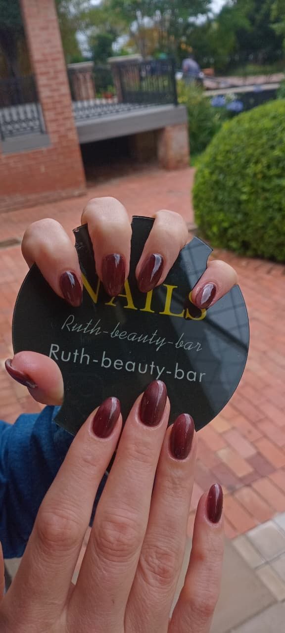 Two hands hold a black circular sign for