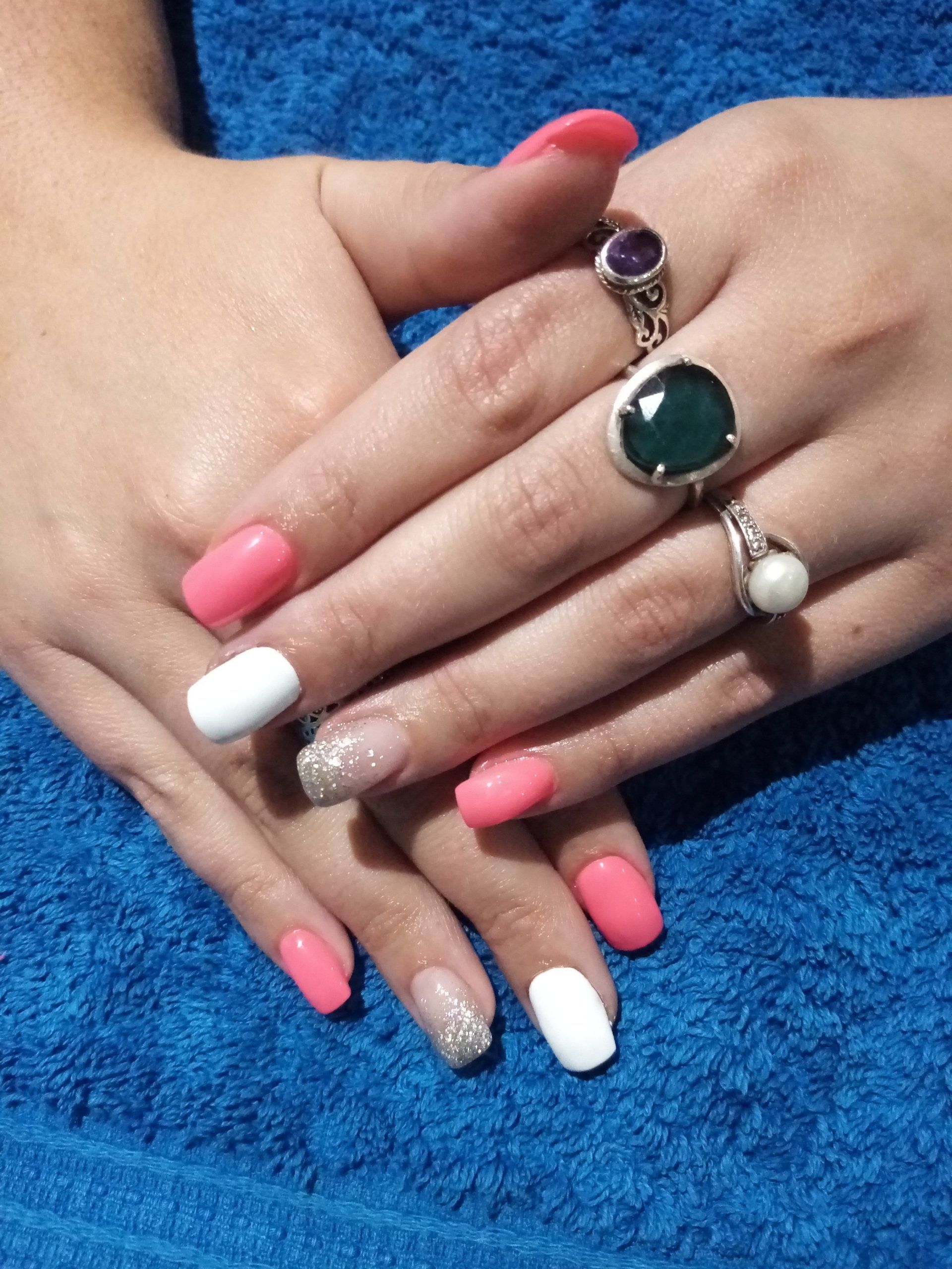 A close up of a woman 's hands with rings on them