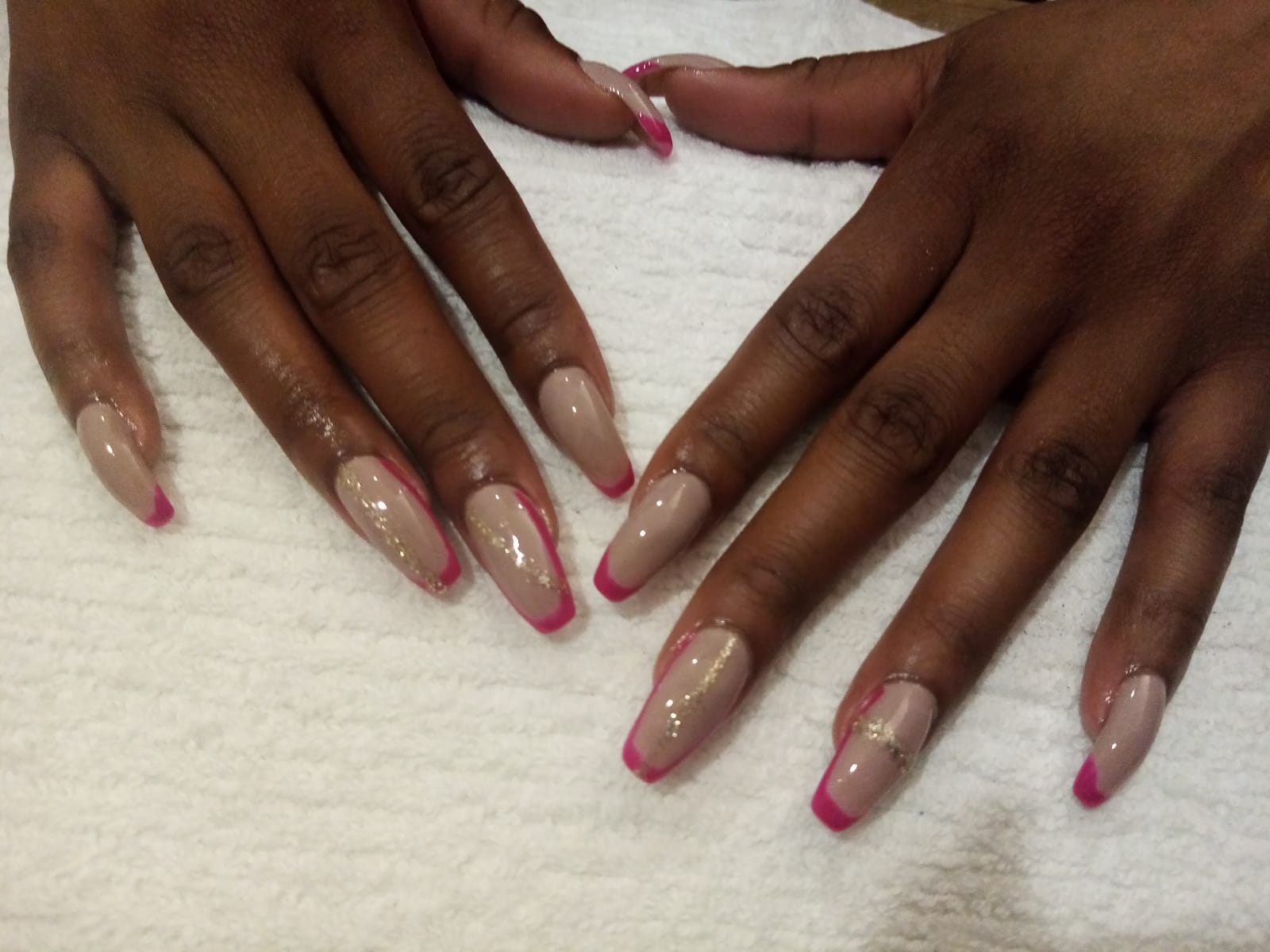 A close up of a woman 's nails on a white towel