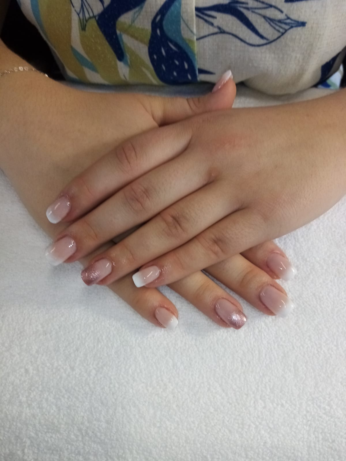 A close up of a woman 's hands with french manicure