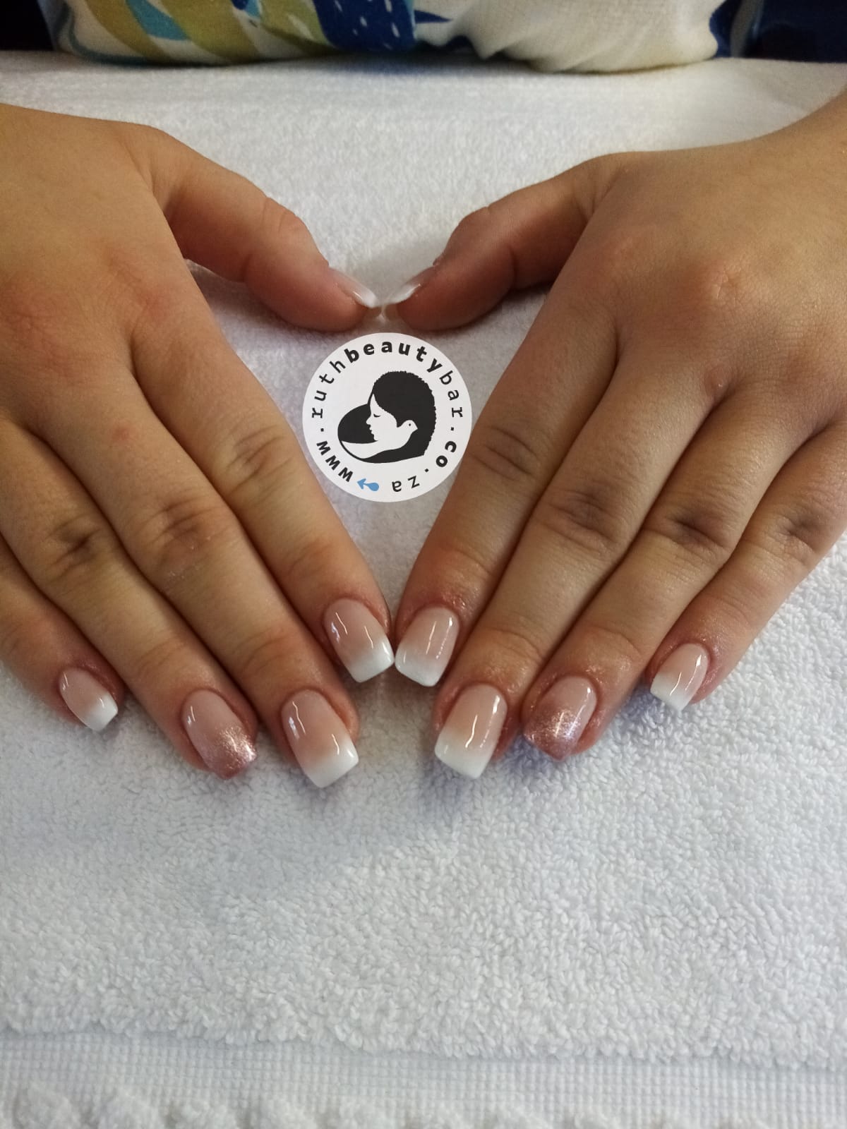 A close up of a woman 's hands with french manicure